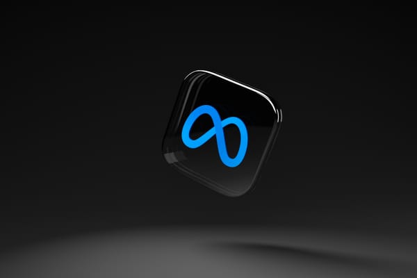 The blue Meta logo on a 3D black tile floating in black space.