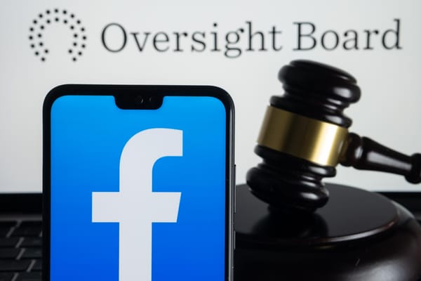 Photo illustration showing the Facebook logo on a phone next to a gavel underneath the Oversight Board logo